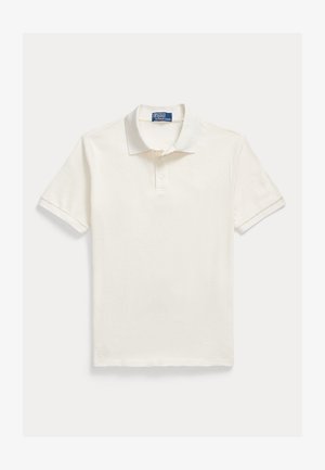 Kortermet poloskjorte i kremfarge, laget av teksturert bomull, med ribbet krage, tre-knappers stolpe og en liten logo nederst.