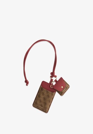 Portacarte e pochette piccola Guess marrone e rossa, attaccate a una cinghia rossa con dettagli hardware color oro e logo del marchio.