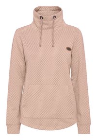 Pull beige avec un col montant, des cordons de serrage et un motif à pois. Comprend une poche avant et des manches avec poignets. Texture de tissu doux.