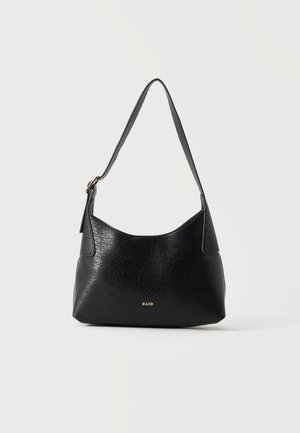 Sac à bandoulière en cuir noir texturé avec une sangle réglable et un petit logo doré "RAID" au centre à l'avant.
