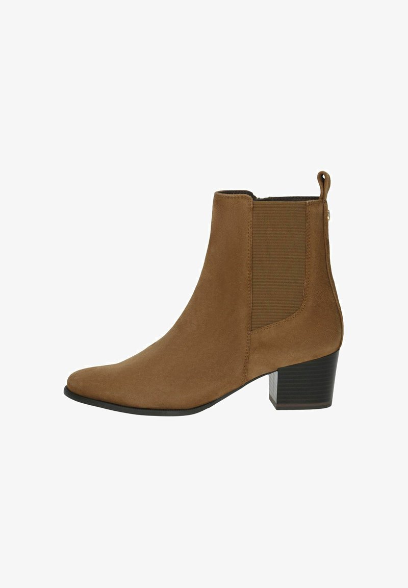 Pruunist nahast pahkluu saapad, millel on elastsed külgpaneelid, terav nina ja tahke konts. Seljaosas on tõmblukk lihtsaks jalga panemiseks. Sile tekstuur.