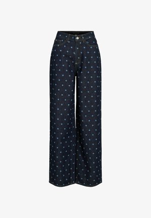 Tamnoplave široke traperice s svijetloplavim točkicama, prednjim kopčanjem na gumbe i patentni zatvarač, te standardnim džepovima.