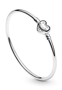 Silver bangle bracelet featuring a heart-shaped charm with engraved text. Smooth, polished finish with round edges, simple coil accents.
