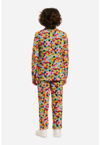 Completo per bambini colorato realizzato in tessuto, caratterizzato da grandi pois multicolori, con un design su misura in rosa brillante, verde, blu e giallo.
