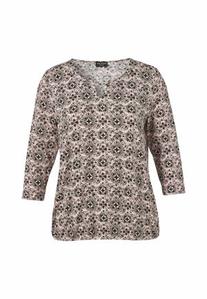 Long-sleeve women's blouse with round neckline and black and white floral pattern on light pink background.