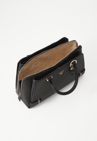 Black structured handbag made of textured material, featuring a gold zipper, logo accent, and beige interior with patterned lining. Open design.
