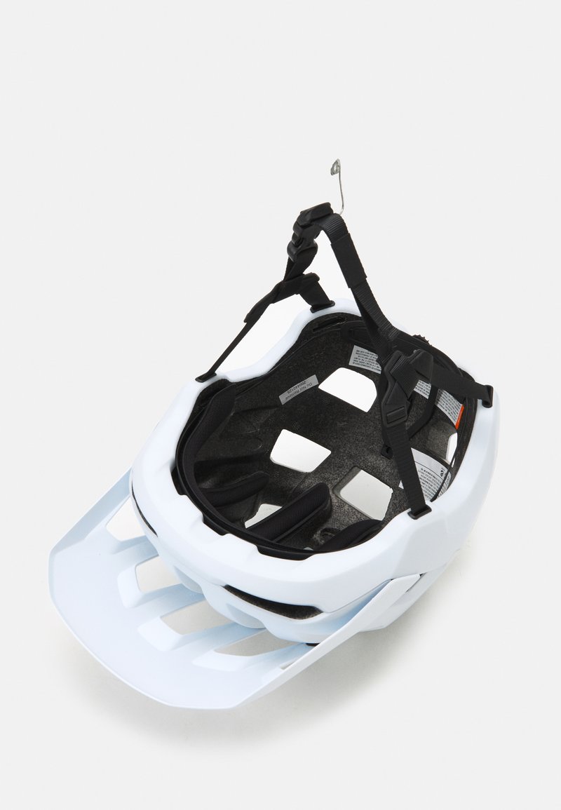 Weißer Fahrradhelm mit schlankem Design, mehreren Lüftungsöffnungen, schwarzem Innenpolster, verstellbaren Riemen und Halterung für ein Sonnenvisier.
