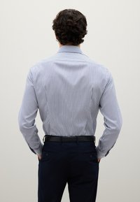 Camicia da uomo a righe blu navy e bianca, con colletto classico e maniche lunghe, dal design slim fit e morbido tessuto di cotone.