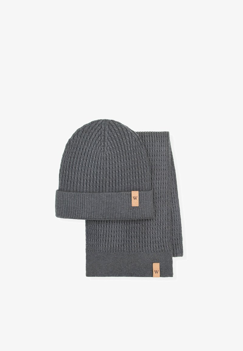 Ciemnoszary zestaw czapki z dzianiny i szalika o prążkowanej fakturze. Każdy element posiada skórzaną metkę z logo "W". Miękki, ciepły materiał.