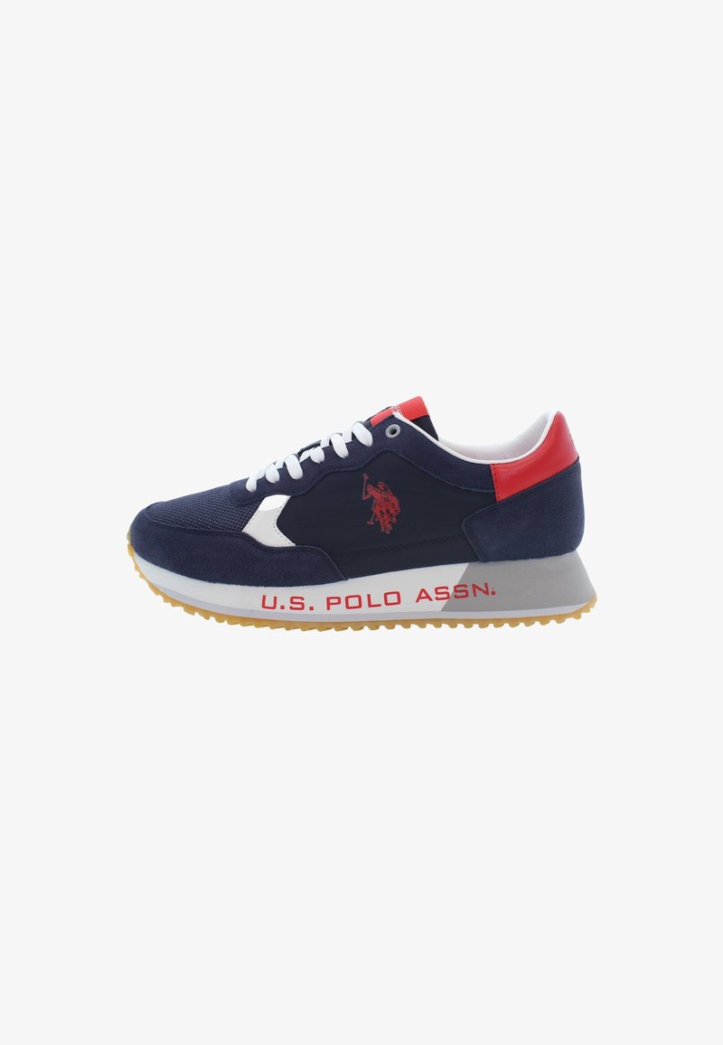 Navy blue athletic shoe with suede and mesh upper, red accents, white laces, logo on side, and a textured rubber sole.
