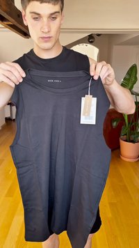 Black sleeveless top made of smooth fabric, featuring a round neckline and side slits. Brand label "Pier One" visible inside.