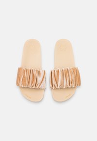Velvet slide sandals with a ruched tan strap, beige footbed, and embossed floral design. Smooth texture with a casual slip-on style.
