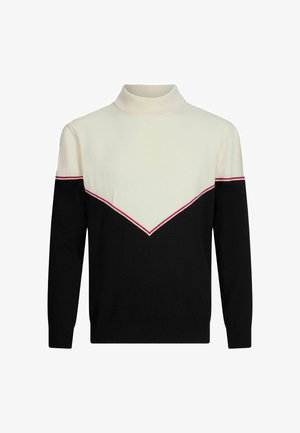 Pull en maille noir et crème avec un col montant à côtes, présentant un motif en chevron souligné de rouge sur la poitrine et les épaules.