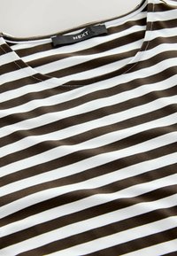Camiseta a rayas marrón y blanca con cuello redondo y textura suave y lisa. La etiqueta dice "NEXT."