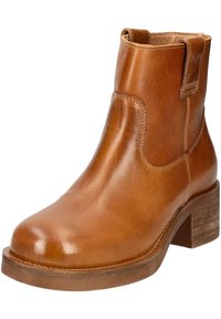 Bottine en cuir marron avec un bout rond, un petit talon carré et des panneaux latéraux élastiques. Texture lisse et détails de couture minimaux.