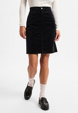 Black corduroy A-line skirt featuring a mid-rise waist, front button closure, and pockets. Finished with a smooth texture and knee-length design.