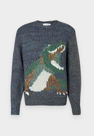 Pletený svetr s designem zeleného dinosaura na modrém, vícebarevném pozadí. Kulatý výstřih a dlouhé rukávy, s texturovanou látkou.
