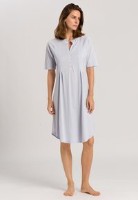 Abito azzurro chiaro a maniche corte realizzato in tessuto morbido. Presenta un colletto, una patta con bottoni e un design plissettato per un fit rilassato.