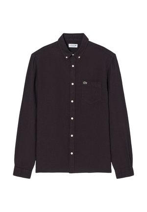 Zwarte blouse met lange mouwen, knopen aan de voorkant, een kraag en een voorzak met een klein groen krokodillenlogo.