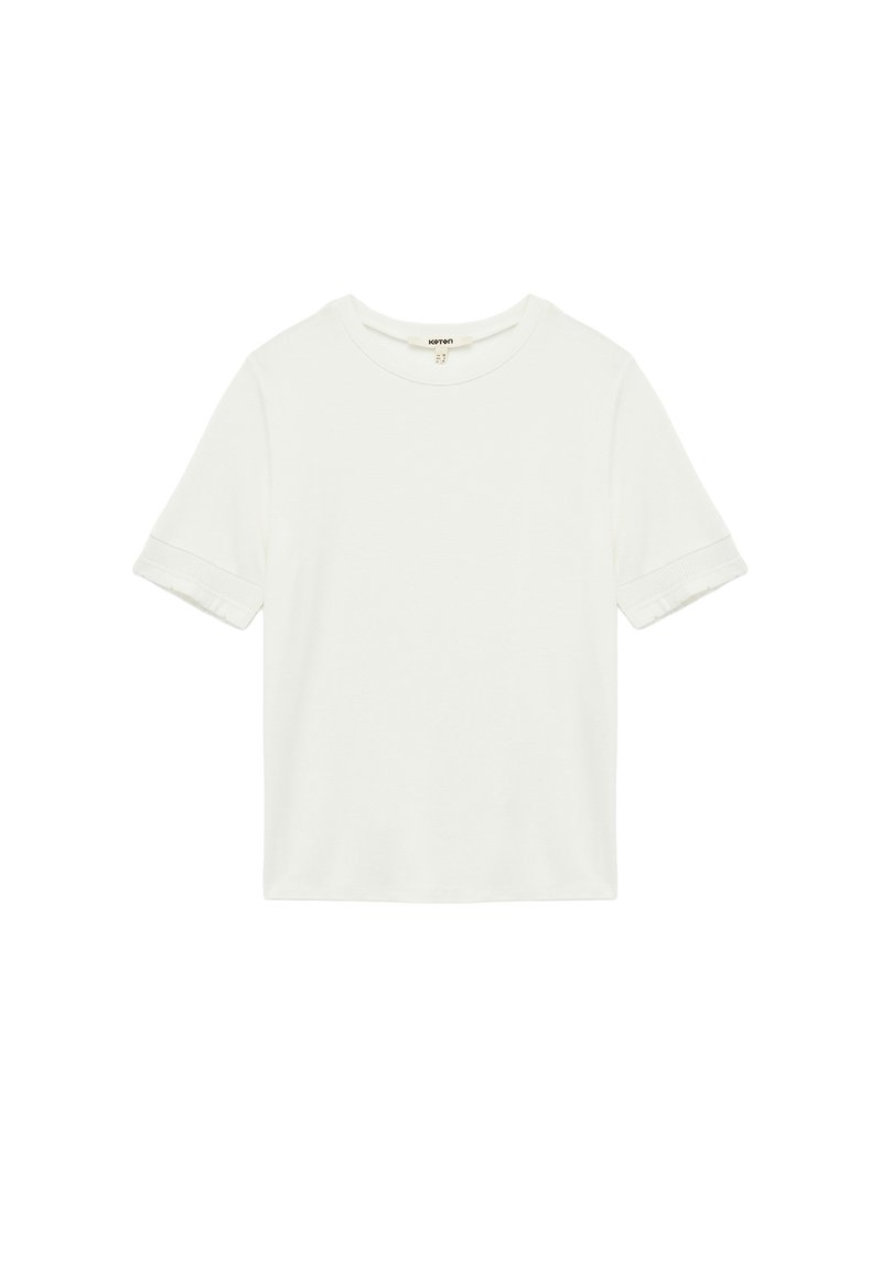 T-shirt bianco a maniche corte in cotone, con scollo rotondo e orli leggermente arrotolati. Tessuto liscio con una vestibilità rilassata.