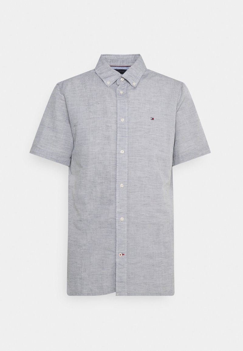 Chemise à manches courtes gris clair avec un col, tissu texturé et petit logo sur la poitrine gauche.