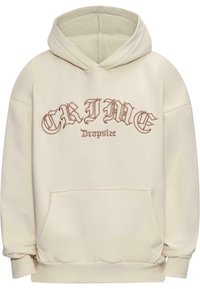 Hoodie crème avec poche kangourou avant, poignets côtelés et capuche avec cordons de serrage. Présente un grand texte graphique marron : "CRIME Dropsize."