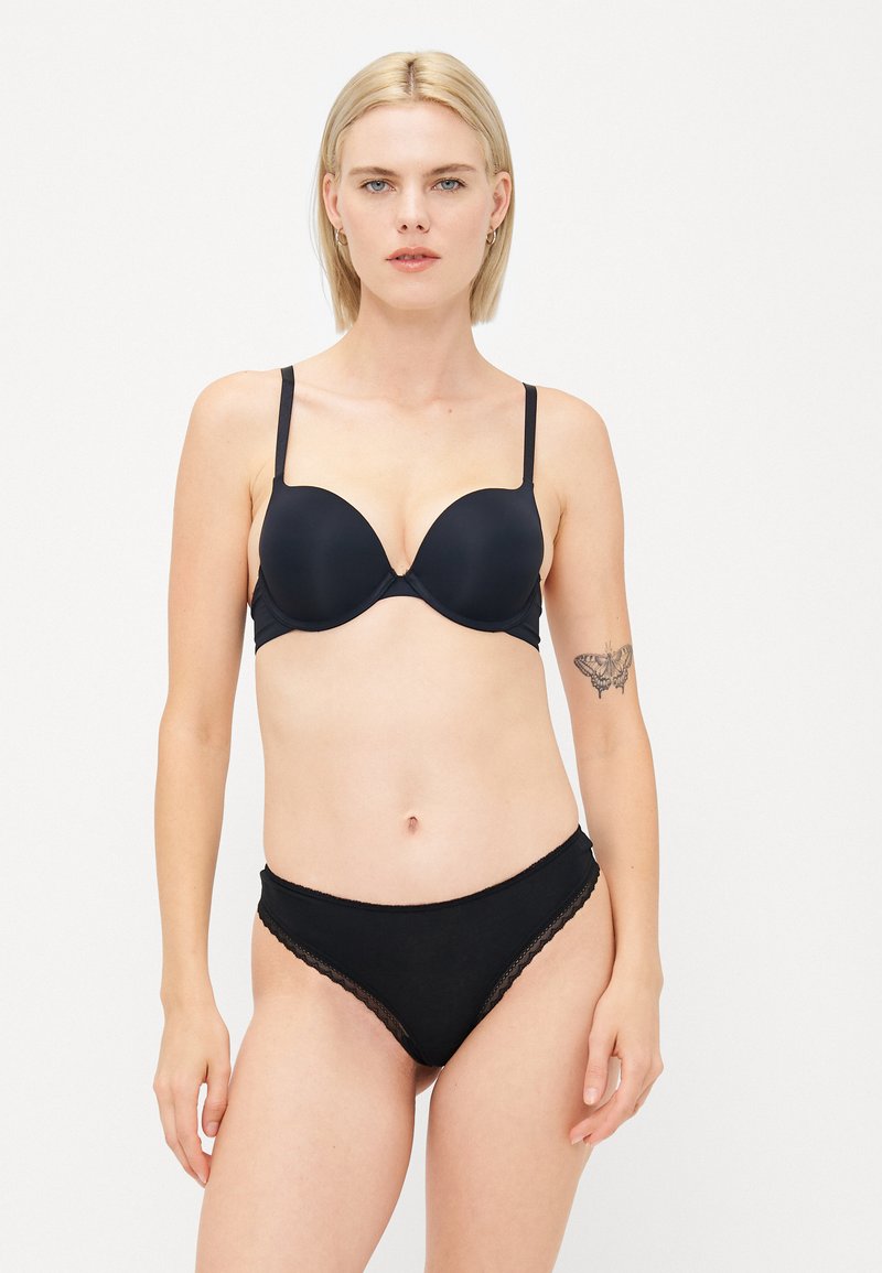 Black underwire bra with smooth cups, adjustable straps, and a lace-trimmed black briefs, featuring a soft, stretchy material.