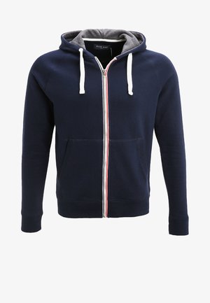 Navy zip-up hoodie with a gray interior, white drawstrings, and a red and white stripe down the center. Features front pockets.