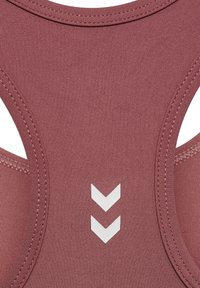 Pink athletic tank top featuring smooth fabric, a round neckline, and white chevron accents on the back. Racerback design enhances mobility.