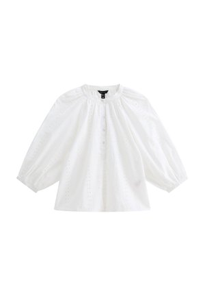 Witte katoenen blouse met pofmouwen, ronde halslijn en knopen aan de voorkant. Bevat een gaatjespatroon en broderie-accenten overal.