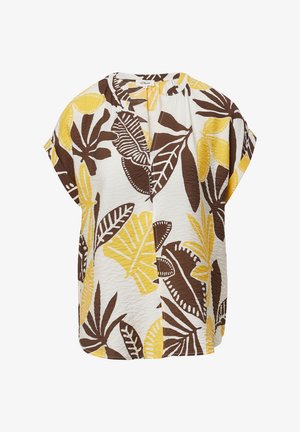 Blouse à manches courtes en blanc avec un motif audacieux de feuilles brunes et jaunes. Texture légère avec une coupe décontractée et un décolleté en V.