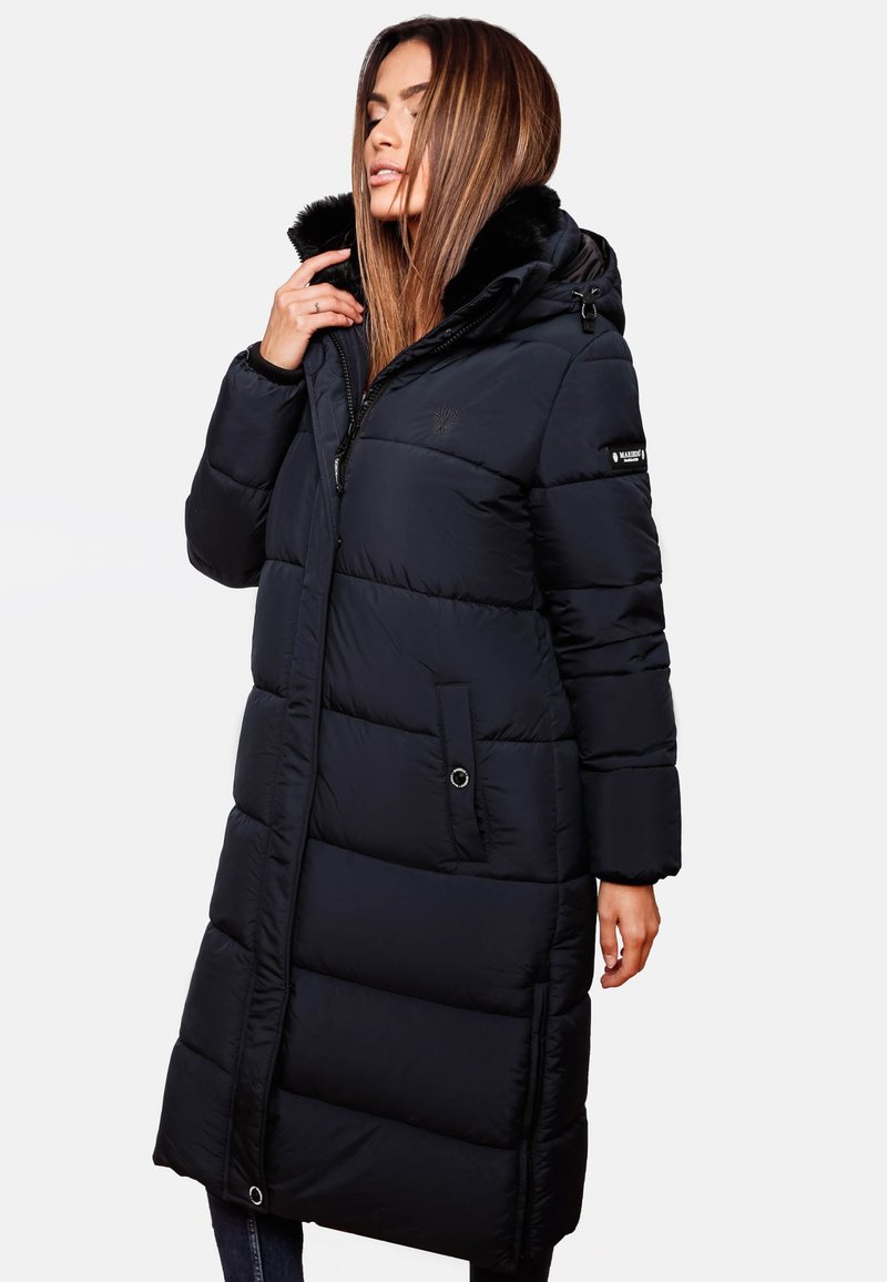 Puffer coat in navy with a faux fur lined hood, zip closure, long sleeves, quilted design, and side pockets. Features branded accents.