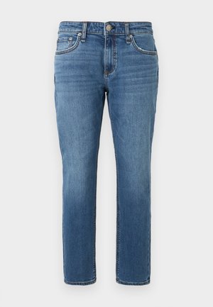 Keskmise pesuga sinised teksapüksid, sirge lõikega, viie taskuga, metallist nööbiga kinnise ja kontrastse õmblusega. Denimkangas kerge pleekimisega.