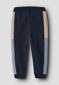 Navy blue jogger pants with beige and light blue side panels, elastic waistband, and ribbed cuffs on a gray background.