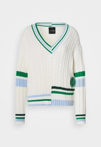 Λευκό ζακάρ ζακέτα με βαθύ V-λαιμόκοψη, με πράσινες και μπλε ριγέ λεπτομέρειες και στρογγυλή πράσινη ταμπέλα με λογότυπο στο μπροστινό μέρος.