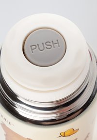 White, round push button atop a silver stainless steel container. Container features colorful animal illustrations and a smooth finish.