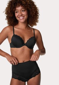Reggiseno nero con bordi in pizzo e spalline regolabili, abbinato a slip neri a vita alta con simili dettagli in pizzo e una finitura liscia.