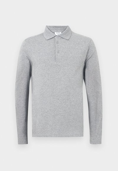 Hallikas pikakäistega polo särk puuvilla segust, klassikalise krae, kolme nööbiga ja peene tekstuuriga.