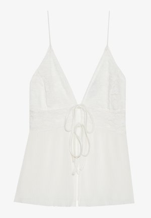 Hvid camisole med blondebuste, dyb v-hals og plisseret kant. Justerbare tynde stropper og detaljer med knytning fortil tilføjer alsidighed.