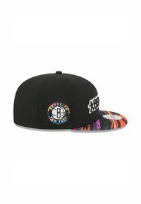 Black snapback cap with a round Brooklyn logo patch, featuring a multicolored graphic brim with bold stripes and contrast stitching.