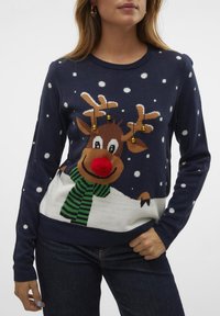 Navy knitted sweater featuring a reindeer design with a red nose, green striped scarf, and yellow bells, accented by white snowflake patterns.
