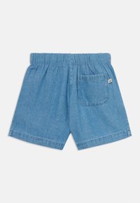Lys blå denimshorts med elastisk midje, baklomme og rett kutt uten synlige mønstre.