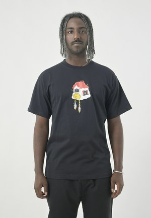 Black cotton t-shirt featuring a colorful graphic design with a house and clock motif on the front. Short sleeves and relaxed fit.