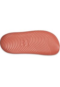 Crocs shoe sole, featuring a textured design with deep grooves. Color is a muted coral shade with branding and size indicators embossed.