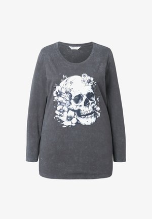 Tumma harmaa pitkähihainen paita, jossa on pyöreä pääntie. Värissä on valkoinen pääkallo graafinen kuvio, jota ympäröi vaaleat kukkakuviot. Pehmeä kangas.