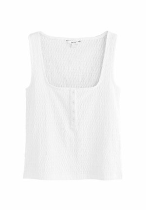 Witte mouwloze textuurrijke croptop met een vierkante halslijn en vier kleine knopen aan de voorkant in het midden.