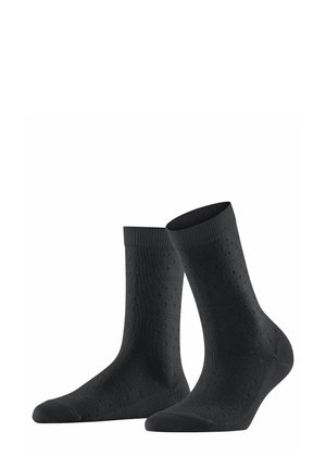 Chaussettes noires en coton avec un motif texturé, des poignets côtelés et un renfort au niveau des orteils. Longueur mi-mollet avec une finition lisse.