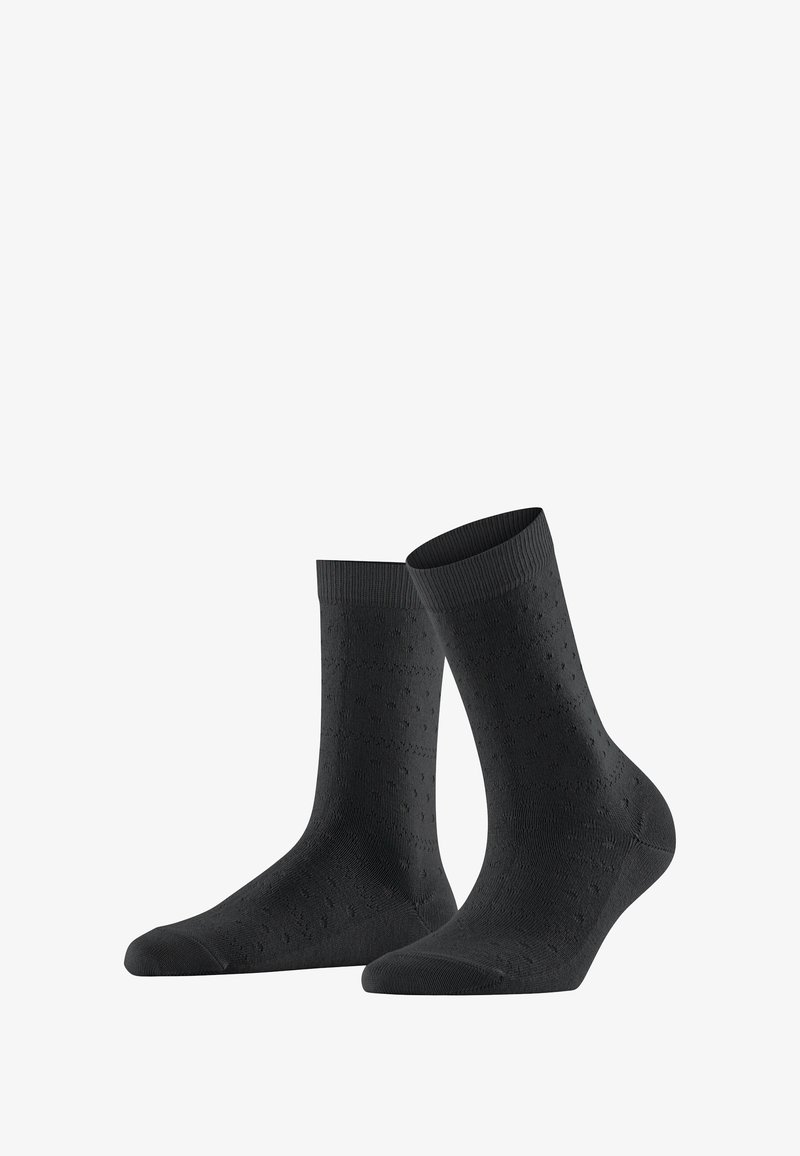 Chaussettes noires en coton avec un motif texturé, des poignets côtelés et un renfort au niveau des orteils. Longueur mi-mollet avec une finition lisse.