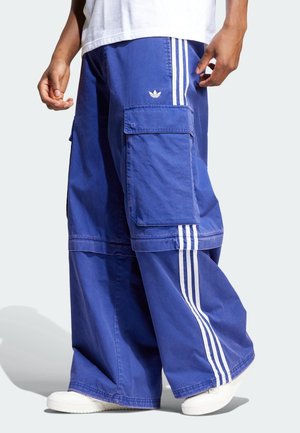 Blue cargo pants made of cotton, featuring large pockets, white three-stripe accents on the sides, and a relaxed fit design.
