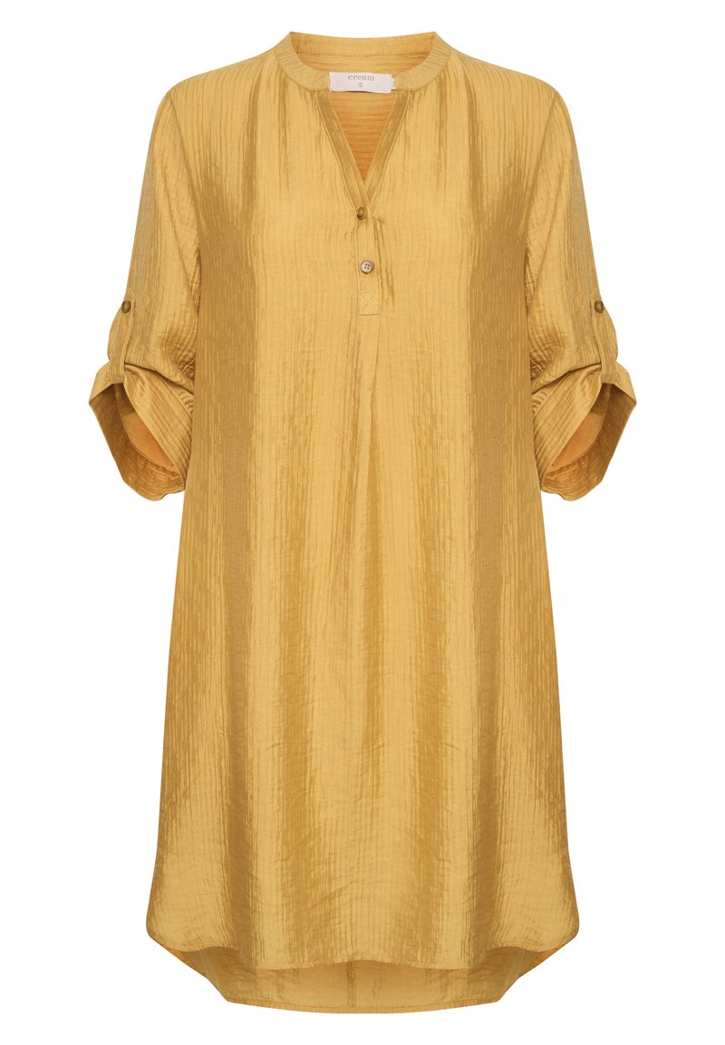 Musta kollane tunika särk, mis on valmistatud kortsulisest kangast, ümarate kaeluste, kolme nupu ja üles keeratud varrukatega, millel on nupu detailid.